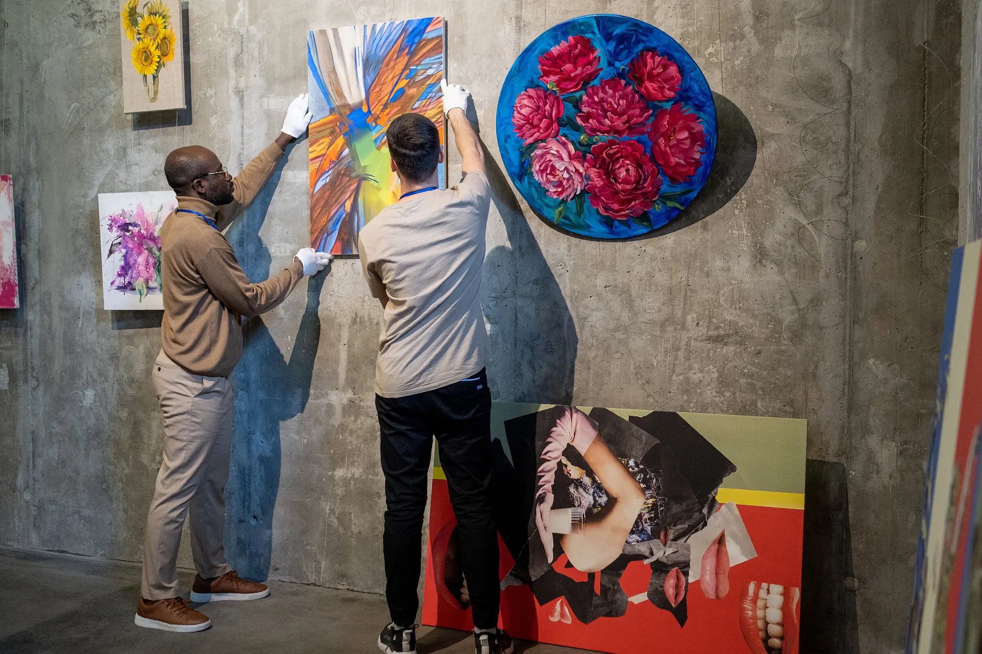 Wide shot — a personal assistant loading pieces for a gallery run
